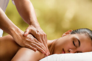 woman enjoying massage in spa.